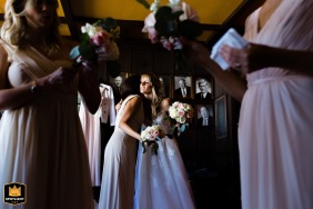 Intimate Emotions on Display: Bar Harbor Bride and Bridesmaids in Soft Pastel Dresse A bride shares an emotional moment with her friends at her Bar Harbor wedding, surrounded by the soft elegance of delicate pastel bridesmaid dresses.